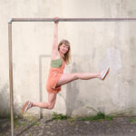woman doing gymnastics on a pole