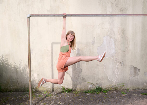 woman doing gymnastics on a pole